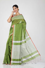 Load image into Gallery viewer, The lady is wearing green handloom saree